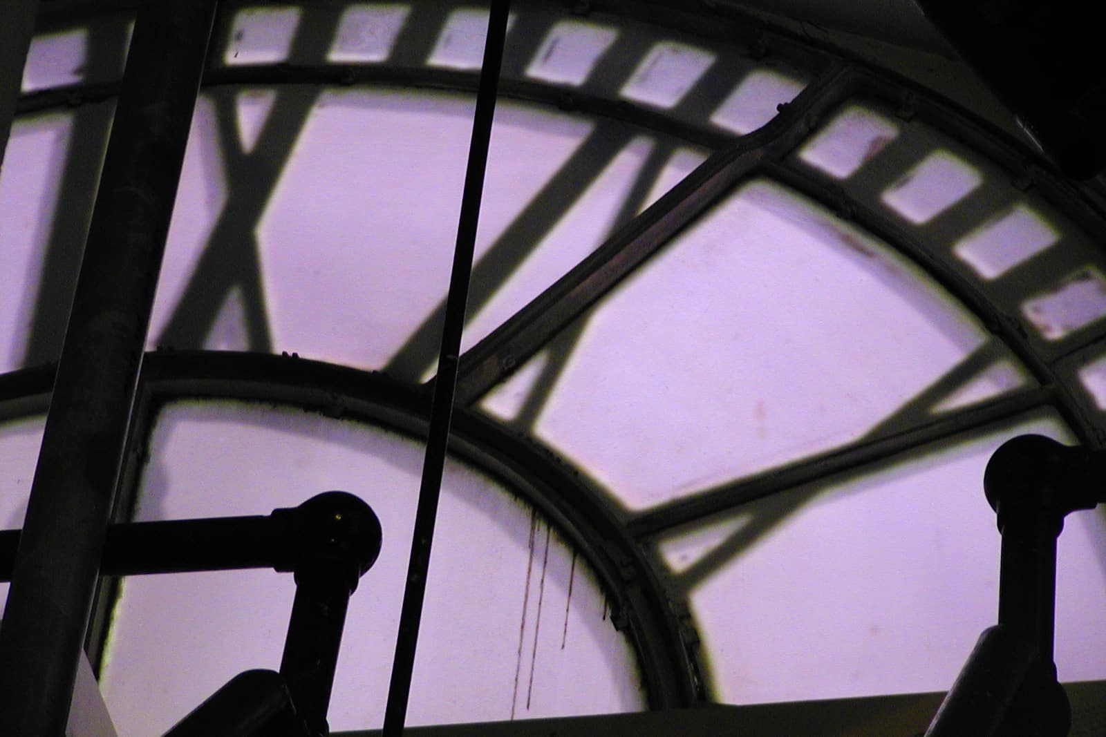 The face of a clock tower as seen from behind ticks.