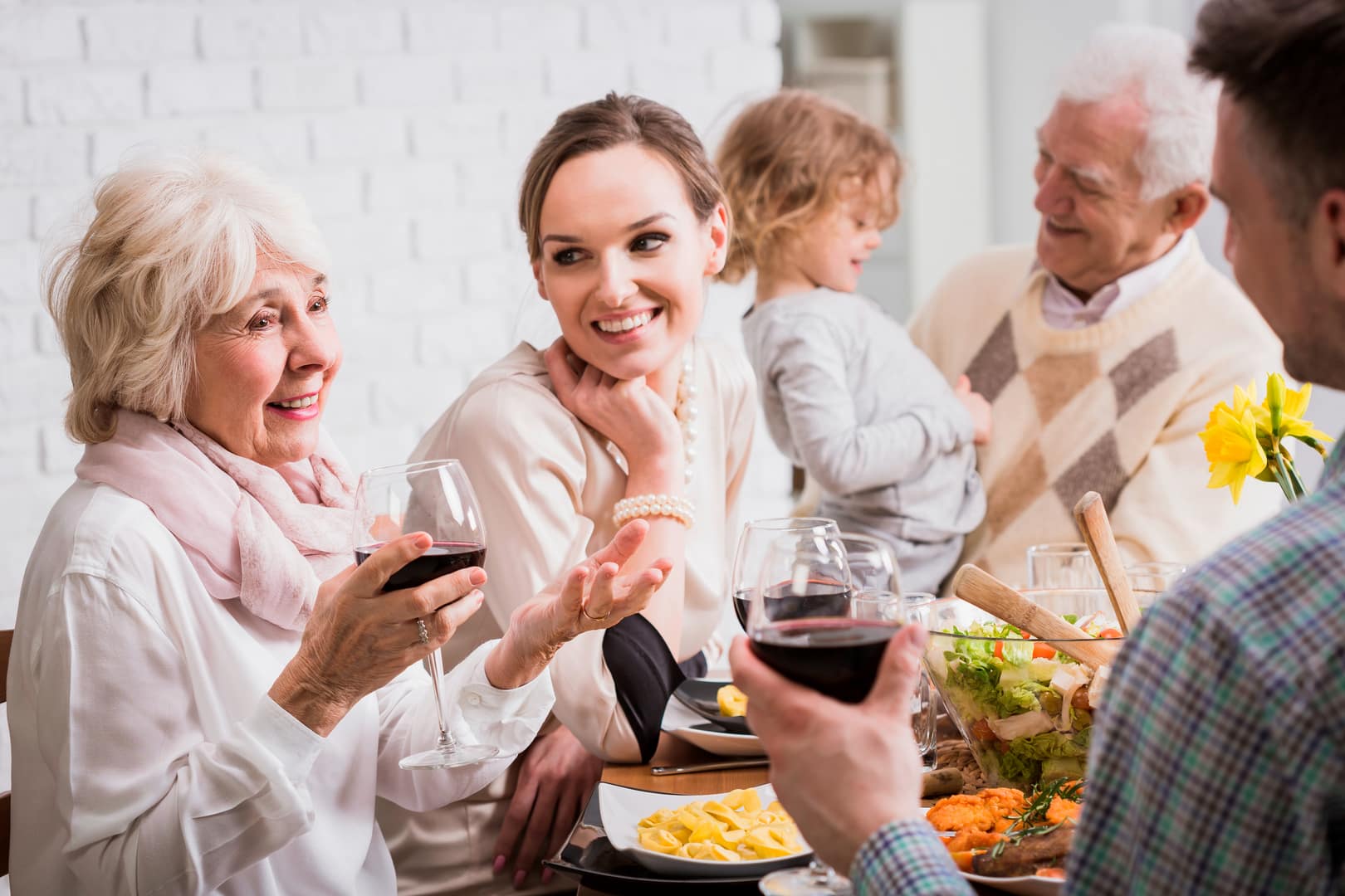 A multi-generational family enjoying dinner together.